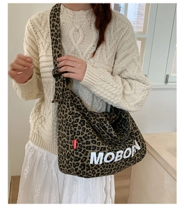 Detail of leopard print tote bag with MOBORN logo and adjustable wide shoulder strap