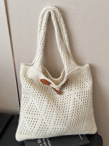 Handmade beige crochet tote bag with hollow knit pattern and horn buckle closure