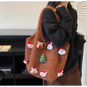 Detail of caramel brown knitted Christmas tote bag with plush reindeer and Santa motifs