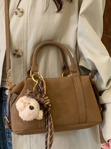 Vintage brown Boston handbag for women with teddy bear charm and striped ribbon detail