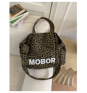 Detail view of leopard print tote bag with MOBOR lettering on canvas material