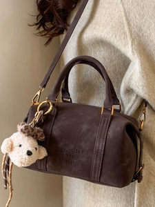 Brown suede Boston handbag with adjustable strap and cute plush dog charm decoration