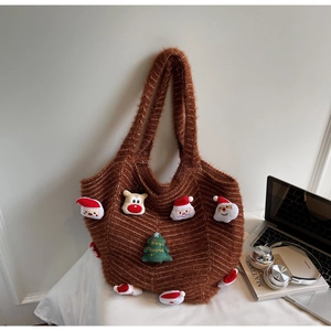 Detailed view of brown knit tote bag with festive 3D Santa and Reindeer plush patches