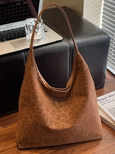 Vintage brown leopard print suede tote bag for women shown in a cozy office setting