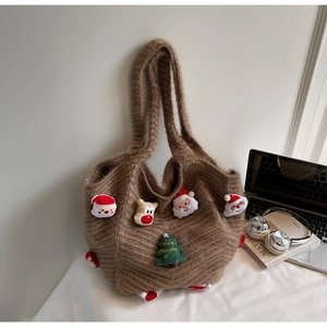 Close-up of brown knit tote bag with Christmas Santa Claus and reindeer 3D patches