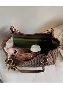 Détails de l'intérieur d'un grand sac cabas tressé marron avec compartiments pour objets
