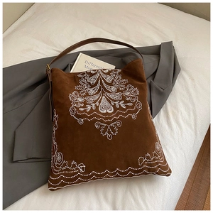 Detailed embroidery on vintage dark brown suede tote bag with floral patterns