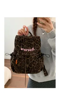 Detail of leopard print backpack with pink embroidery and drawstring closure