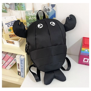 Detail view of a creative black cartoon crab backpack with large claws and durable fabric
