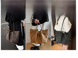 Detail view of large drawstring tote bags in multiple colors with shoulder carry style