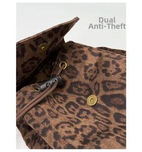 Detail of leopard print canvas backpack with magnetic snap and drawstring security closure