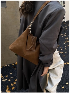 Macro view of vintage frosted dark brown underarm bag with small detachable pouch for women