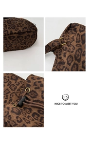 Detail of leopard print canvas backpack with drawstring closure and metal buckles