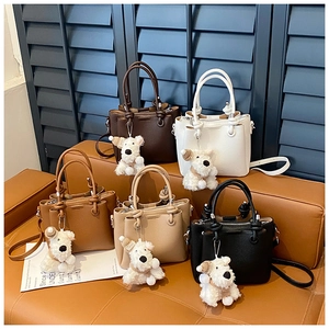 Multi-color leather handbags in five shades with cute plush dog charms and shoulder straps