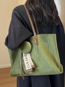 Fashionable green velvet tote bag with diamond quilting and brown leather straps