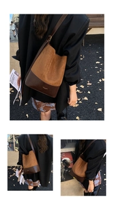 Detail view of brown suede and smooth leather bucket bag with gold metal buckle