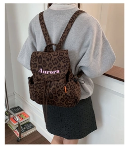 Leopard print canvas backpack with pink Aurora embroidery and side drawstring pocket detail