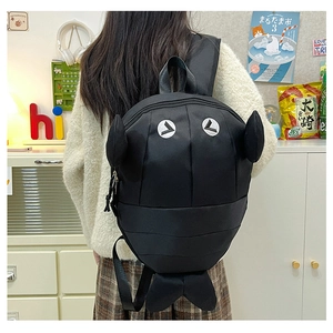 Close-up of a creative 3D shark-shaped backpack with fins and embroidery details