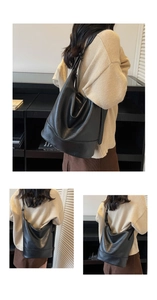 Makro-Detail der mattschwarzen Ledertextur und des minimalistischen Hobo-Taschendesigns