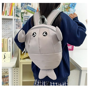 Detail view of the lightweight grey shark-shaped backpack with 3D fins and tail decoration