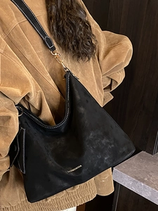 Vintage matte black hobo shoulder bag with white contrast stitching and a small pouch