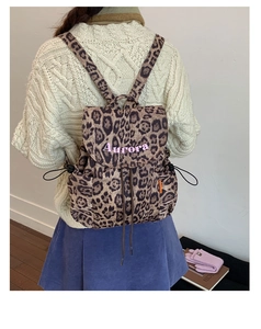 Close-up of leopard print canvas backpack with drawstring and Aurora embroidery