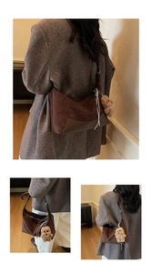 Detail of dark brown crescent crossbody bag featuring a plush bear charm and suede texture