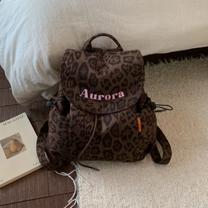 Detailed view of leopard print canvas backpack with Aurora pink embroidery and drawstring