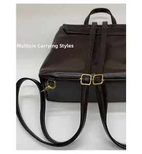 Detail of adjustable vintage metal buckles and leather straps on dark brown backpack