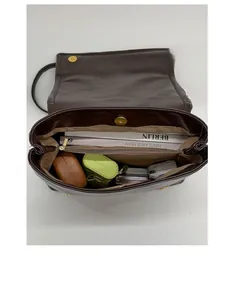 Spacious interior of dark brown vintage leather backpack with central zipper divider