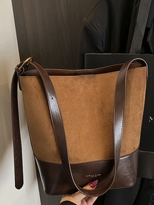 Vintage suede bucket bag with contrast leather trim and adjustable shoulder strap