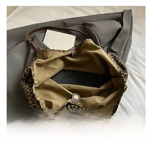 Detail view of the leopard print tote bag interior with magnetic closure and khaki lining