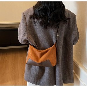 Detail of vintage leopard print suede underarm bag with adjustable leather shoulder strap