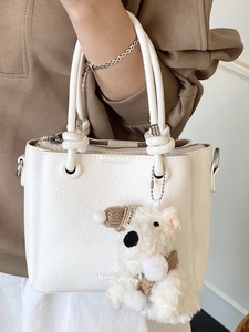 White litchi grain leather handbag with braided knot handle and cute bear charm