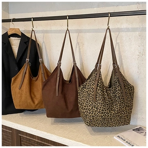Three suede tote bags in ginger, coffee and leopard print with adjustable straps