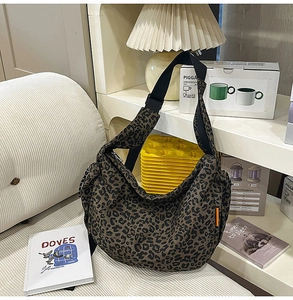 Vue détaillée du grand sac bandoulière léopard avec sangle en toile noire et décor cosy