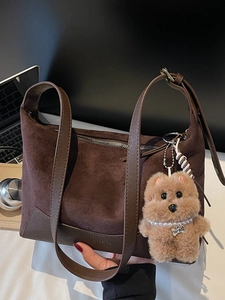 Brown leopard-style faux suede shoulder bag with plush dog charm and fashion text