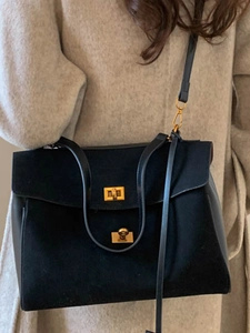 Retro black faux suede tote bag with dual gold twist locks and adjustable shoulder strap