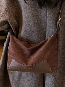 Brown suede and leather拼接 crossbody bag with retro leopard print texture on a model