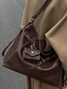 Vintage dark brown leather tote bag with white stitching and mini pouch on strap