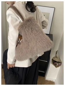 Detail of light brown plush tote bag with woven leather handles and fluffy texture