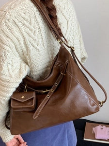 Retro brown large capacity backpack with white stitching and mini purse charm