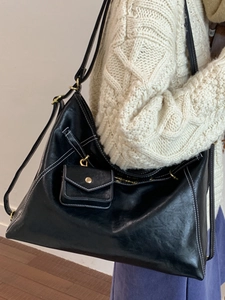 Vintage black leather tote backpack with white contrast stitching and a small pouch
