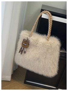 Detail of plush tote bag showing soft faux fur texture and woven rope handles