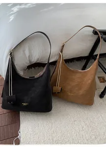Detail of vintage moon-shaped tote bags in black and tan with contrast white stitching