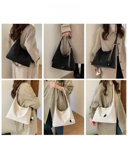 Detail showing versatile styling of a large hobo shoulder bag in black and cream beige