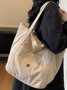 Large capacity beige nylon tote bag with front pocket and round logo for daily commuting