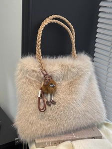 Chic beige plush tote bag with braided handles and leopard pendant for winter style