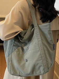 Olive green large capacity canvas tote bag with front pocket and shoulder straps