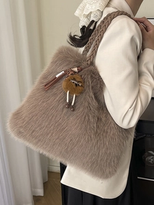 Faux fur tote bag in light brown with woven handle and cute cartoon charm